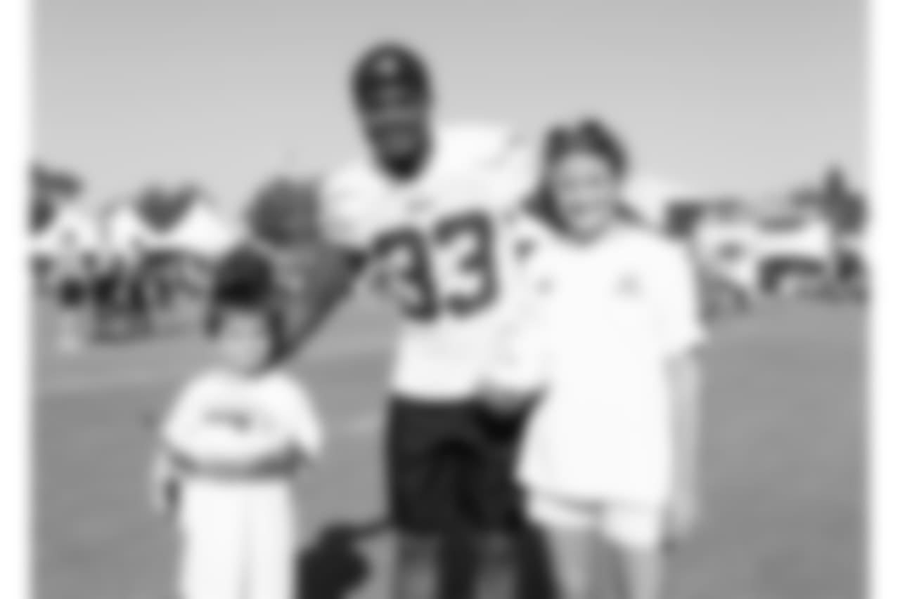 Defensive back (33) Curtis Mikesell of the Los Angeles Rams poses for a photo with a fan during Day 3 of Training Camp, Saturday, July 28, 2018, in Irvine, CA. (Will Navarro/Rams)
