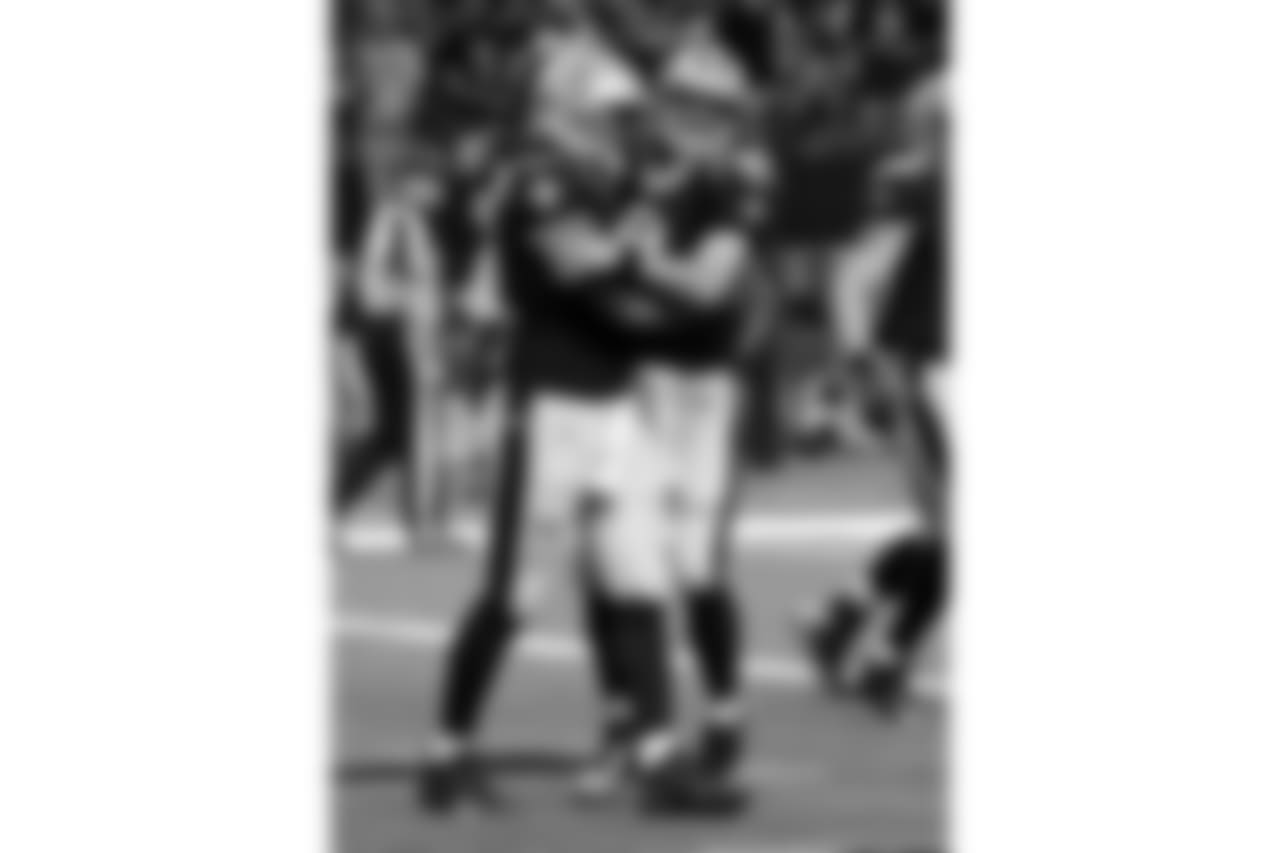 New Orleans Saints quarterback Drew Brees (9) hugs tight end Michael Hoomanawanui after the two connected on a touchdown reception in the second half of an NFL football game in New Orleans, Sunday, Oct. 15, 2017. (AP Photo/Bill Feig)