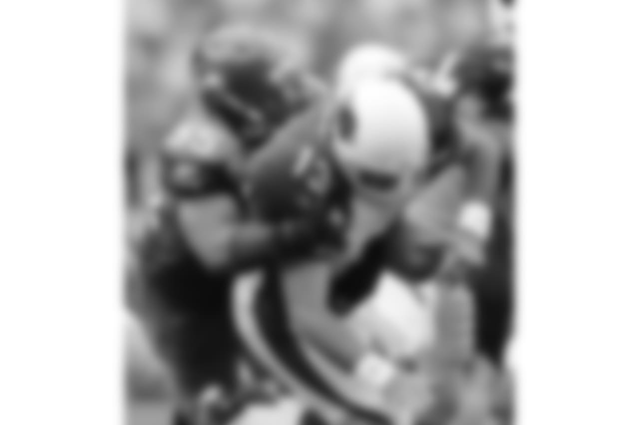 * FILE * Arizona Cardinals quarterback Kurt Warner loses control of the ball but regains control as he is sacked by Seattle Seahawks' Darryl Tapp during the fourth quarter of a football game in Seattle, in this Sept. 17, 2006 file photo. One week after Warner was named NFC offensive player of the week in Arizona's season-opening victory over San Francisco, he was blamed, in part, by his coach for the offense's struggles in Sunday's 21-10 loss at Seattle. (AP Photo/John Froschauer)