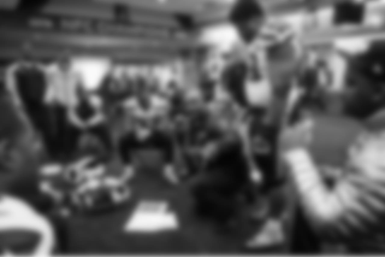 Inside the Seahawks locker room, coaches and players met, stressing the need to not let up despite a 22-0 lead. Travis Jones met with the defensive linemen as head coach Pete Carroll watched over his shoulder.