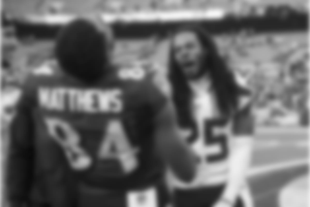 After the game, former teammates Chris Matthews and Richard Sherman share a laugh. Earlier in the game, Matthews tackled Sherman after an interception by grabbing his braids.