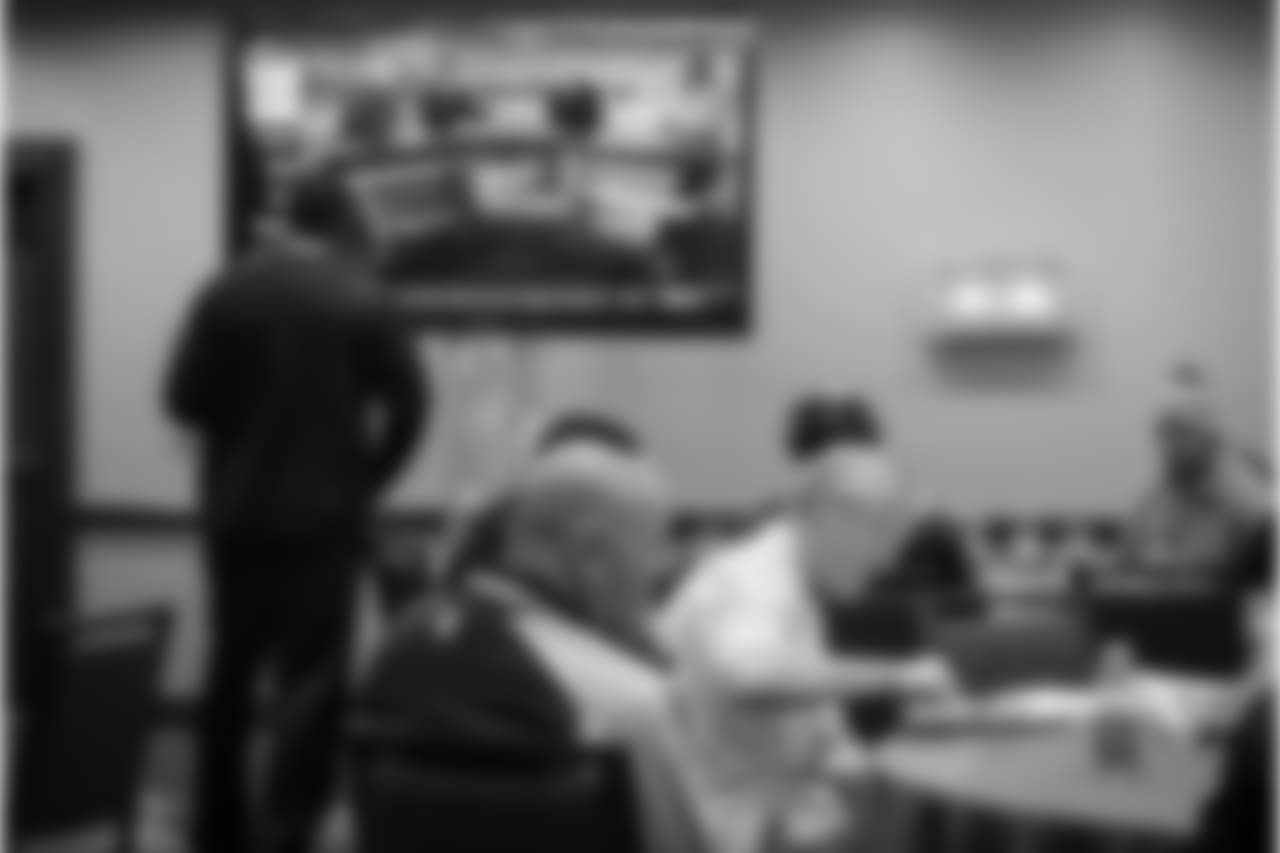 It's 9:45am on Super Bowl Sunday and head coach Pete Carroll eats breakfast with assistant coach Tom Cable. A nearby television has already started its game day coverage, but most players and coaches pay it no mind as they go about their business.