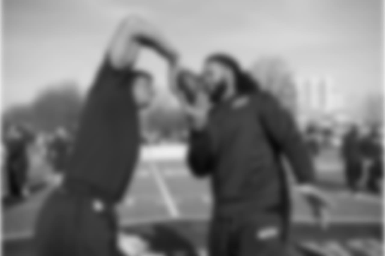 Russell Wilson and Will Tukuafu engage of round two of their football gripping game during walk thru on Saturday.
