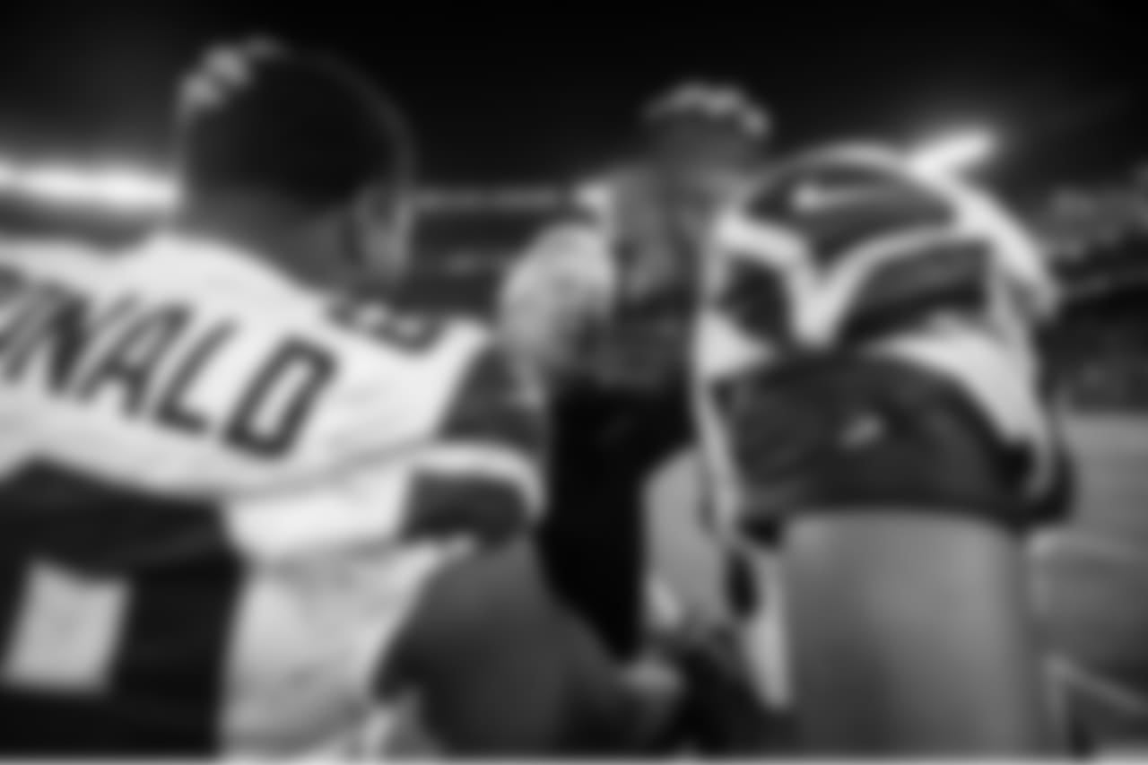 Pete Carroll congratulates defensive players Clinton McDonald and K.J. Wright.
