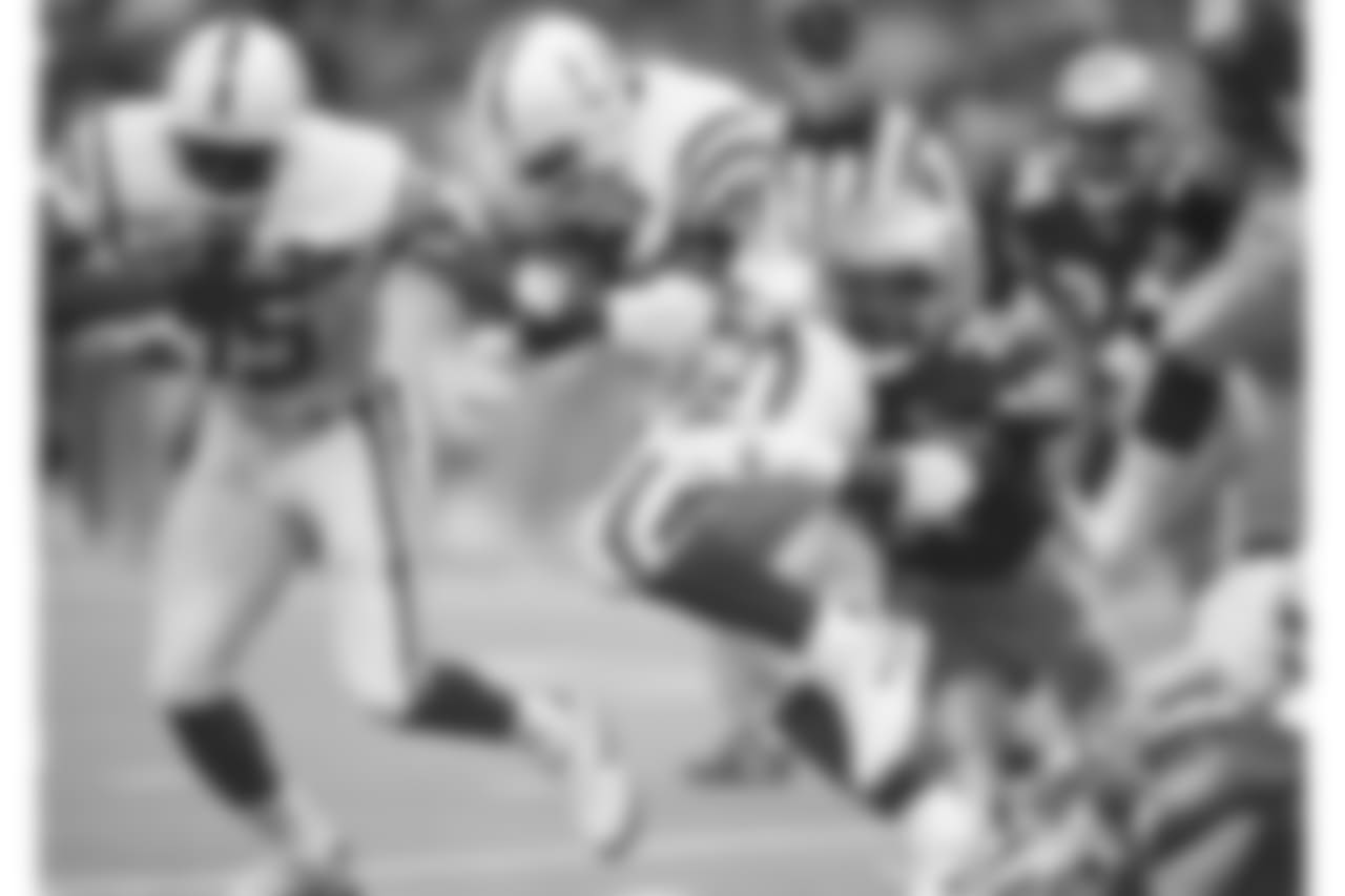 Indianapolis Colts Marshall Faulk (28) is stopped by Seattle Seahawks Rafael Robinson (21) after a five-yard gain in the second quarter of their game in Seattle, Dec. 4, 1994. (AP Photo/Barry Sweet)
