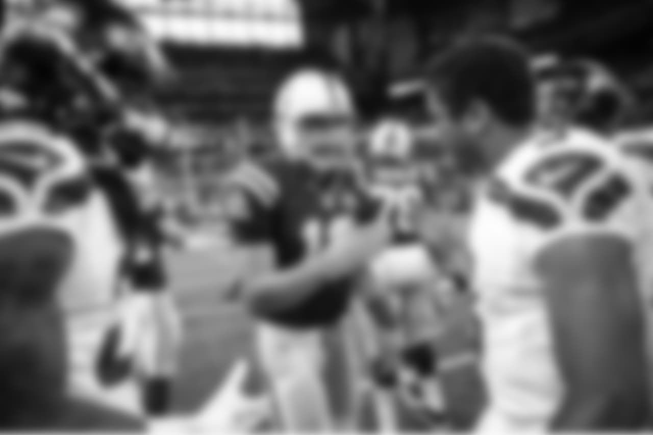 After the game, second-year quarterbacks Andrew Luck and Russell Wilson greet each other at midfield.