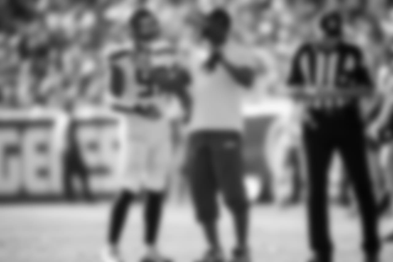 Injured Seahawk Cliff Avril gives advice to defensive end Marcus Smith in the fourth quarter.