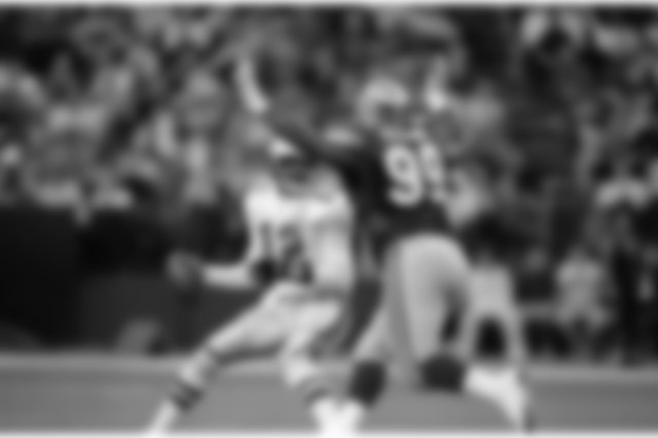 Quarterback Randell Cunningham (12) of the Philadelphia Eagles is unable to avoid the rush of Cortez Kennedy (99) of the Seattle Seahawks during the fourth quarter of NFL game in Seattle, Dec. 13, 1992. (AP Photo/Bill Chan)