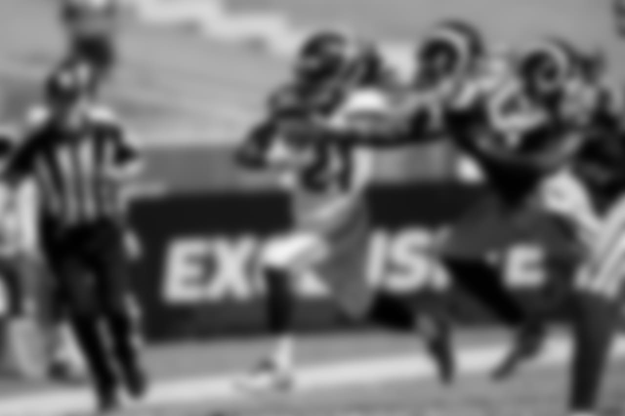 Seattle's J.D. McKissic races up the right side.