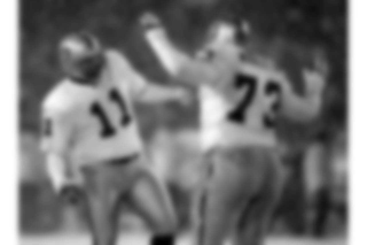 Oakland Raiders kicker Sebastian Janikowski (11) celebrates with guard Frank Middleton after his second field goal of the game during the third quarter of the AFC Divisional Playoff game against the New England Patriots at Foxboro Stadium, in Foxboro, Mass., Saturday Jan. 19, 2002. (AP Photo/Charles Krupa)