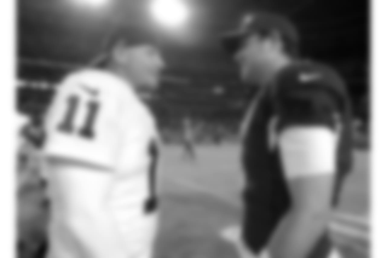 Oakland Raiders kicker Sebastian Janikowski (11) and Arizona Cardinals quarterback Carson Palmer (3) after an NFL preseason football game, Friday, Aug. 12, 2016, in Glendale, Ariz. (AP Photo/Rick Scuteri)