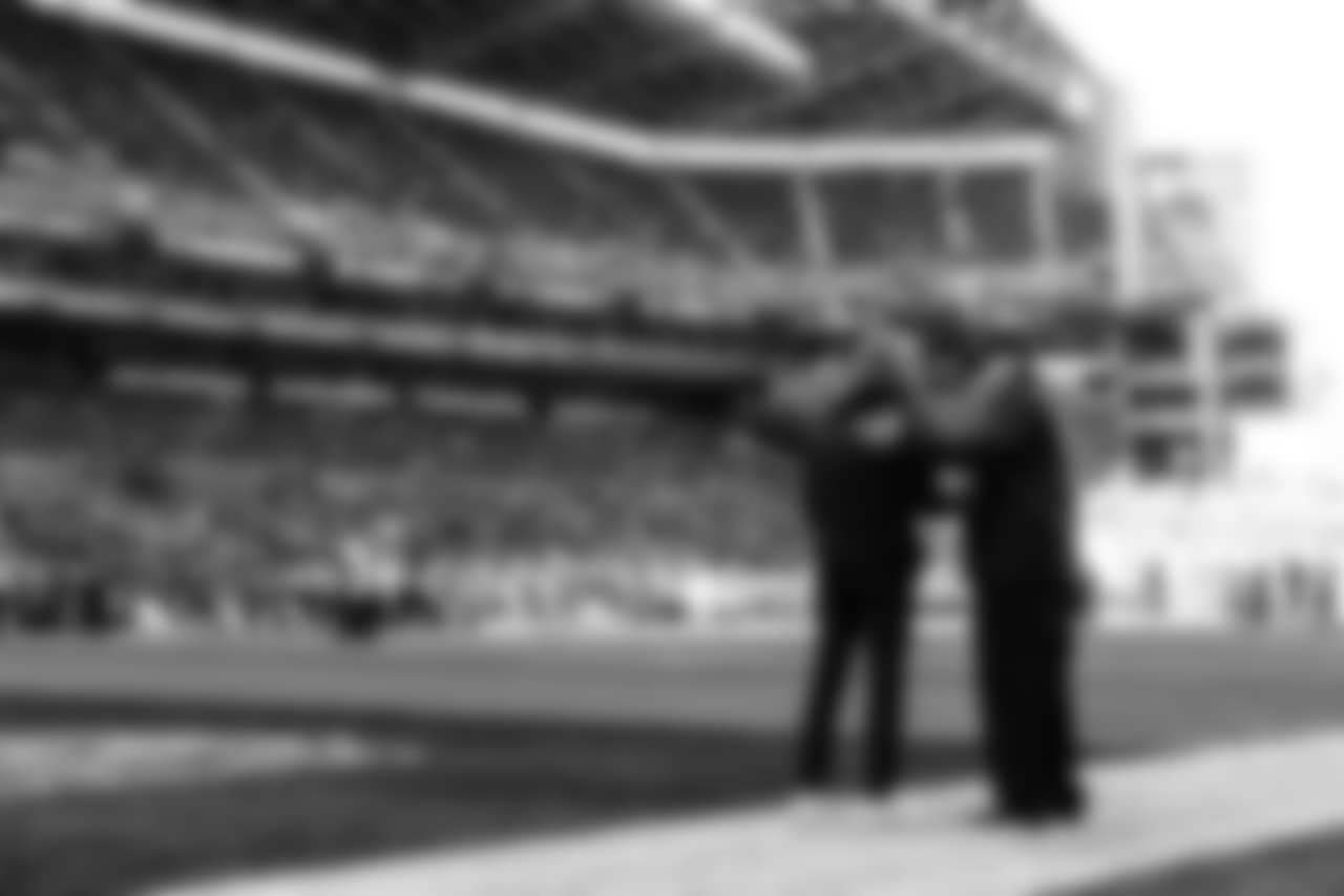 Seahawks head coach Pete Carroll and team owner Paul Allen shake hands on the field before the game.