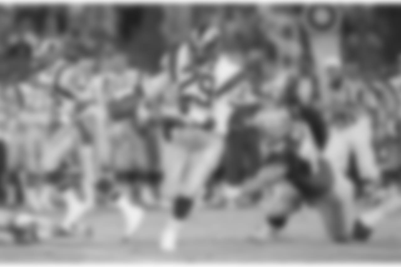 FILE - In this Aug. 13, 1987, file photo, Los Angeles Rams running back Eric Dickerson (29) breaks away as Seattle Seahawks nose tackle Joe Nash misses the tackle during the first quarter of an NFL preseason football game in Anaheim. Eric Dickerson is thrilled his Rams have returned to Los Angeles after 21 years away, but the Hall of Fame running back says the current players in the horned helmets must be ready for both the challenges and the opportunities presented by playing in the nations glitzy entertainment capital. (AP Photo/Lennox McLendon, File)
