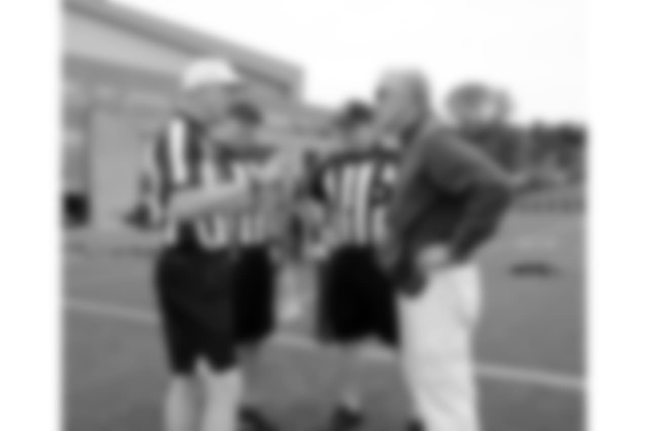 Head Coach Pete Carroll meets with practice officials.
