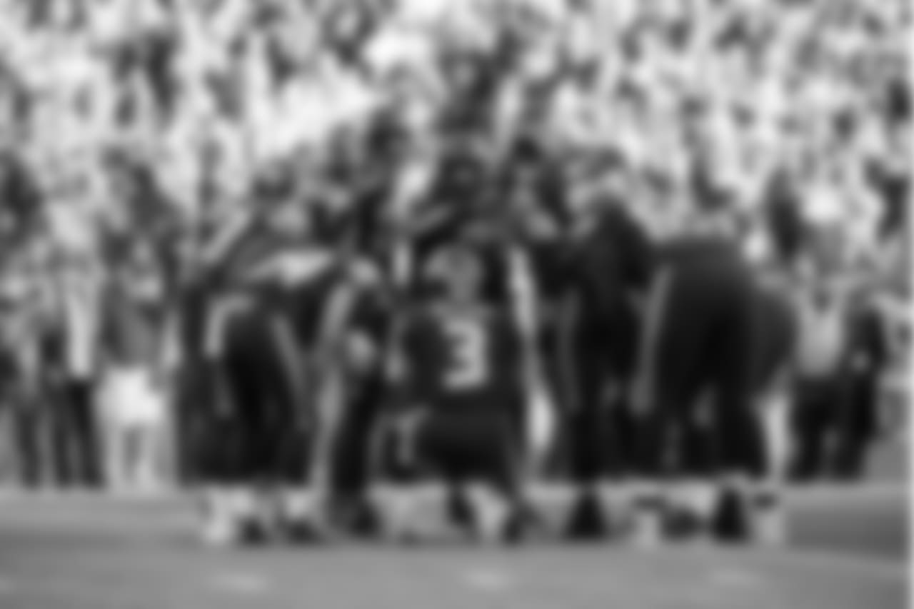 The Seahawks huddle around quarterback Russell Wilson during the second quarter.