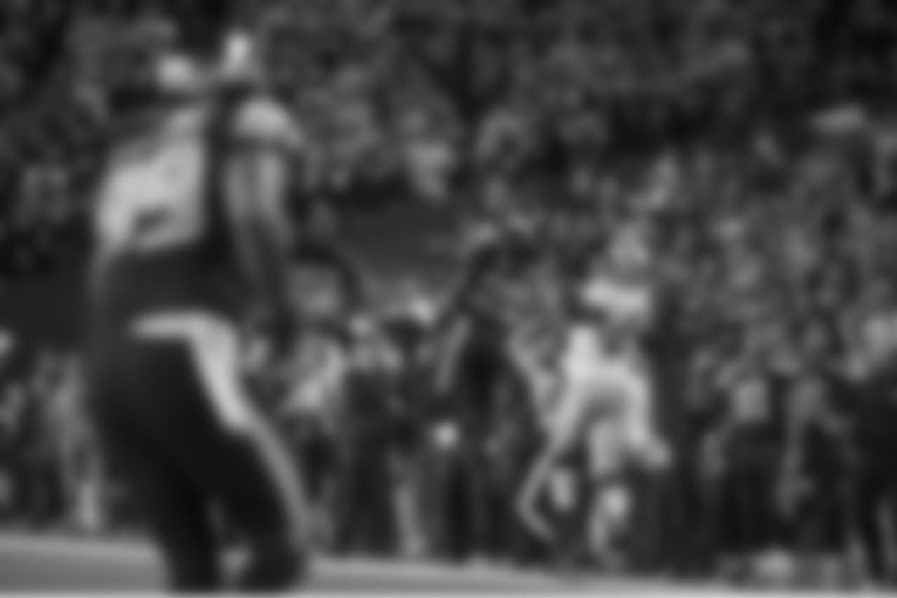 Seahawks cornerback Richard Sherman skies to intercept a deep pass intented for San Francisco's Vernon Davis along the Seattle sideline as head coach Pete Carroll (lower right) watches.