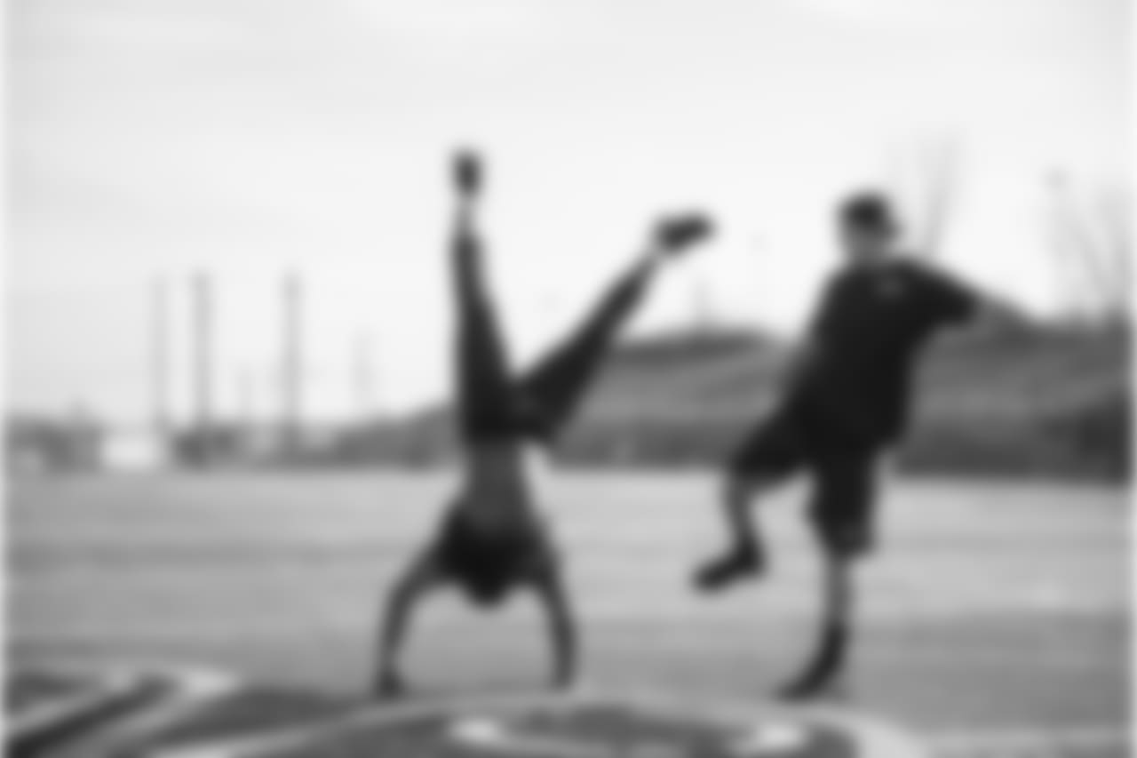 Receiver Kevin Smith shows off his handstand skills as offensive lineman J.R. Sweezy does his best impression of kicker Steven Hauschka.