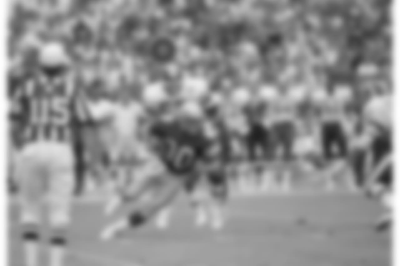 Seattle Seahawks receiver Steve Largent (80) comes down with a catch, to tie the NFL record of 127 consecutive games with a reception as Redskins linebacker Rich Milot (57) tries to bring him down in the first half of their game in Washington, Sept. 28, 1986. Largent tied Harold Carmichael's record with this catch near the end of the first half. (AP Photo/Tom Reed)
