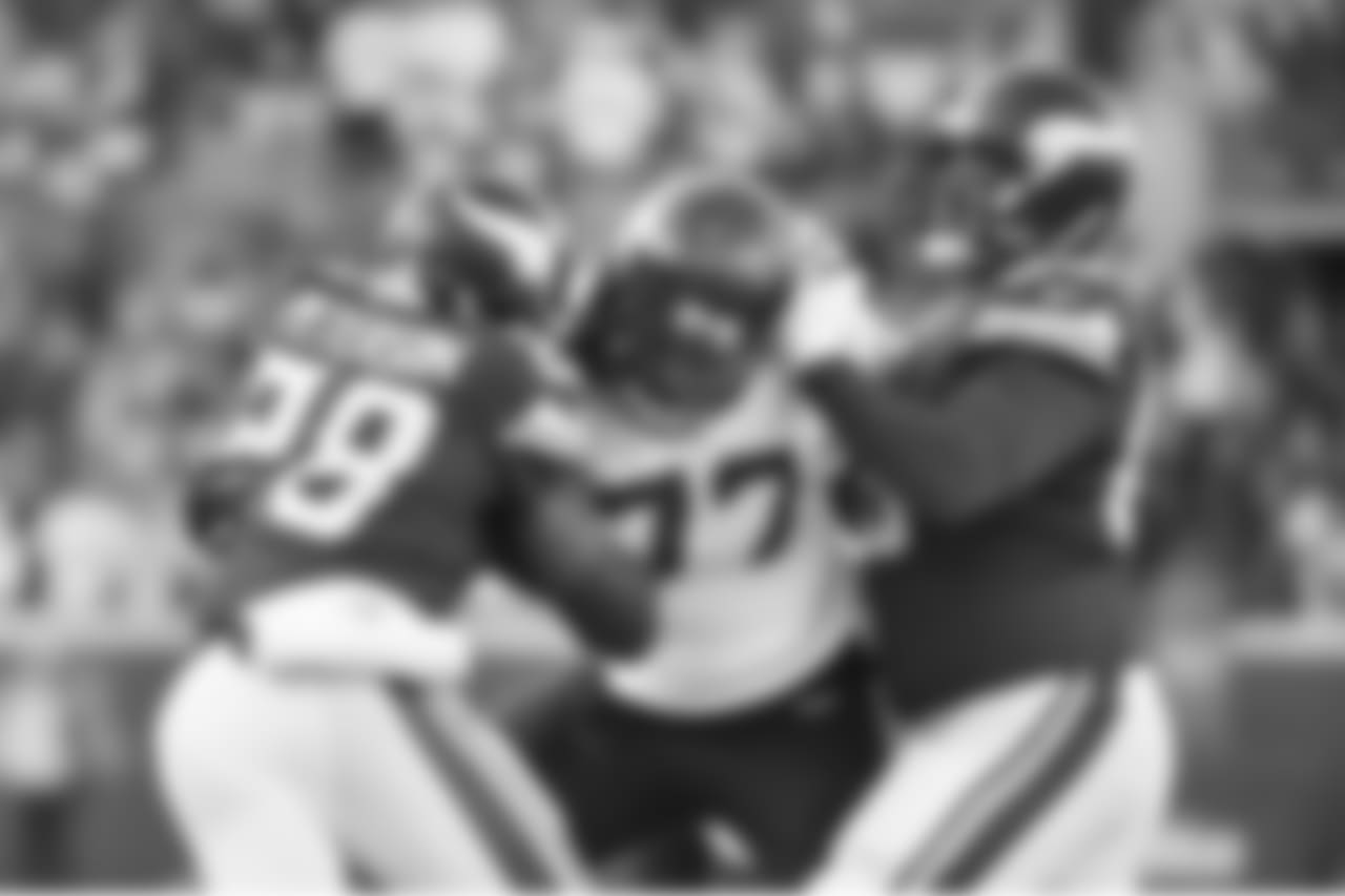 The Vikings sought to establish their running game with the league's leading rusher in Adrian Peterson, but Seahawks defensive end Michael Bennett fought off a block with one hand while tackling Peterson with the other on this stop in the first quarter.