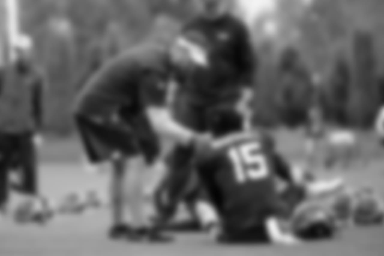 Offensive coordinator Brian Schottenheimer, left, and WR Brandon Marshall, right