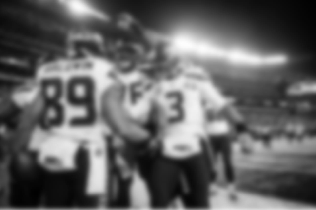 Wide receiver Doug Baldwin is congratulated by teammates Russell Okung and Russell Wilson after his touchdown capped the scoring, making it 43-8.