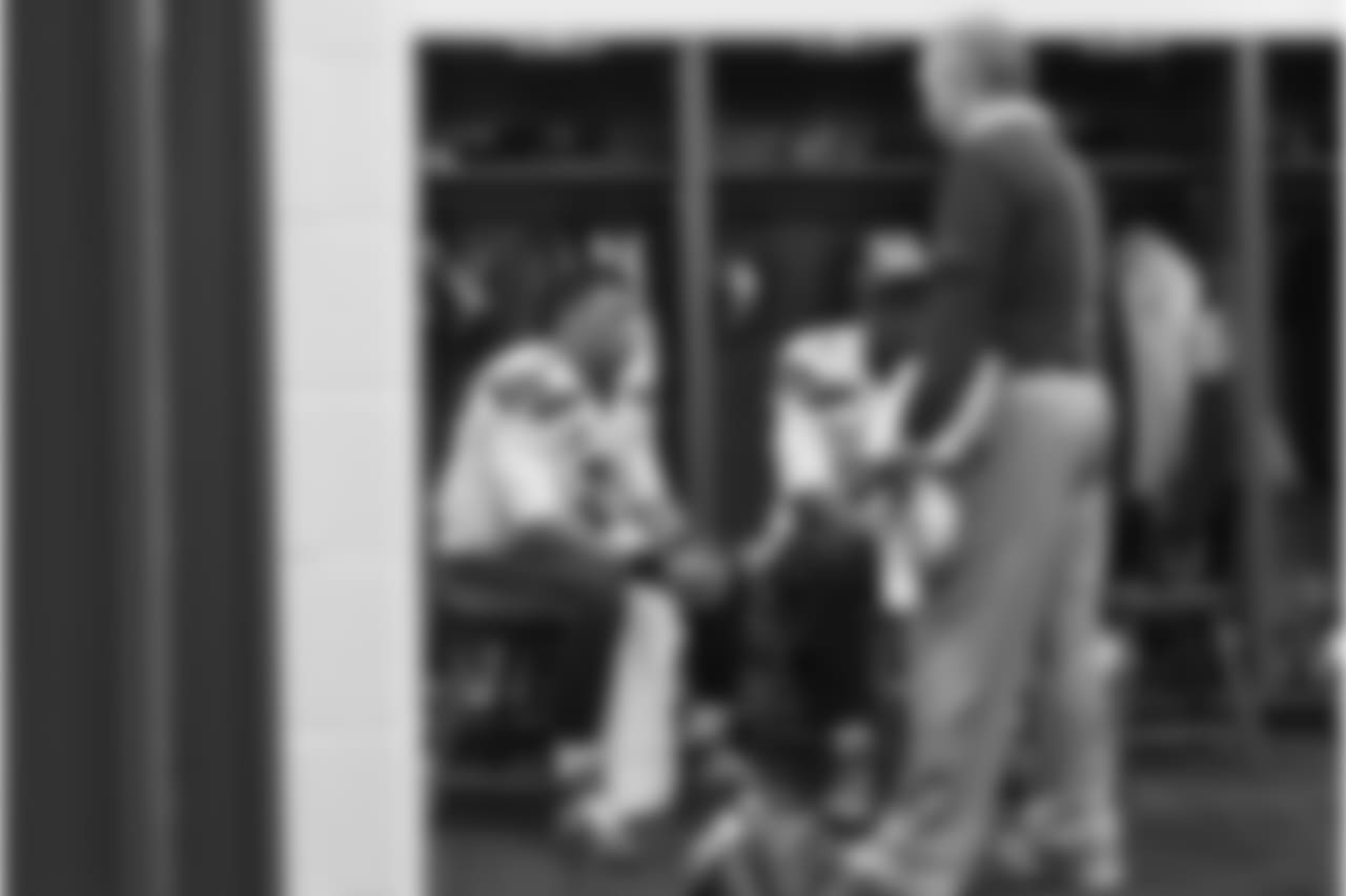 In another corner of the locker room, quarterbacks Russell Wilson and Tarvaris Jackson listen to position coach Carl Smith.