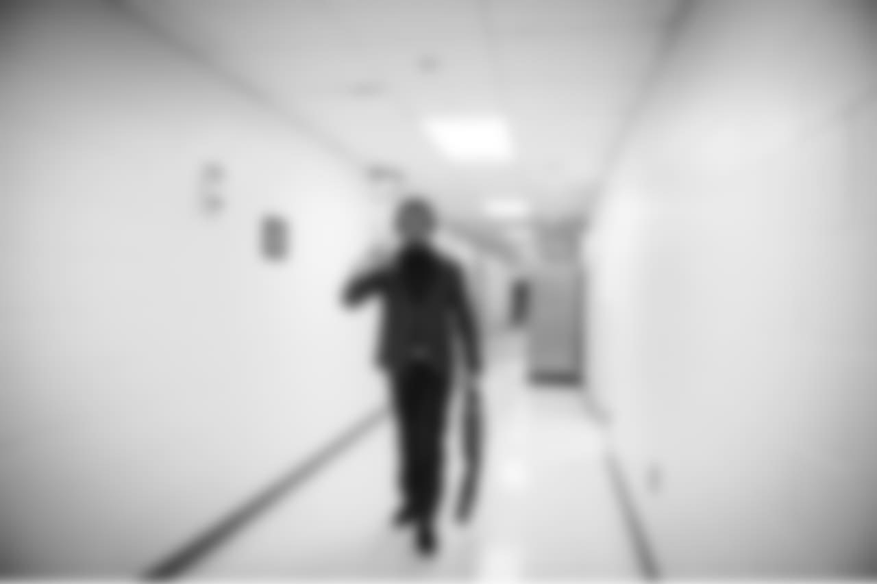 Walking alone along a back corridor of the hotel, safety Earl Thomas flashes the "Legion of Boom" sign as he makes his way to the bus.