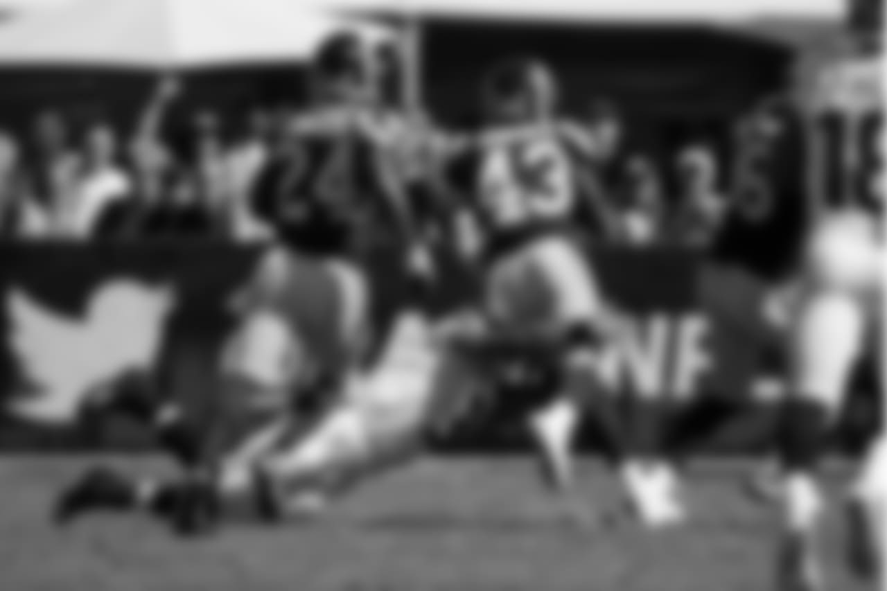 Seahawks quarterback Russell Wilson helps save a touchdown by tackling Rams safety John Johnson III after Johnson intercepted a pass thrown by Wilson.