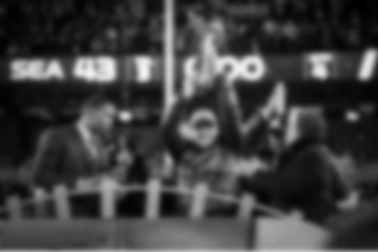 Seahawks owner Paul Allen raises the Lombardi Trophy for the first time in team history after watching his team demolish the Denver Broncos, 43-8 in the Super Bowl.