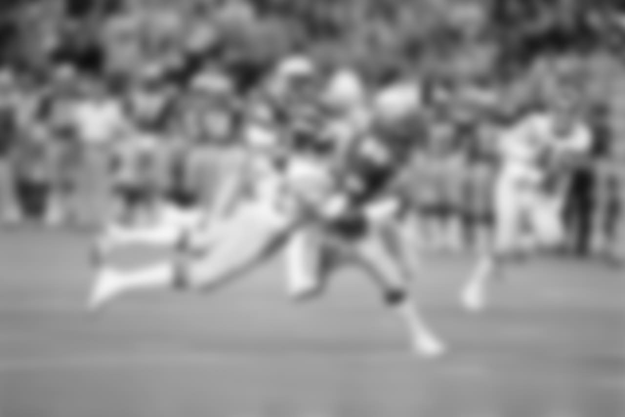 Seattle Seahawks receiver Steve Largent (80) is brought down by San Diego's Gill Byrd (22) after catching a pass good for 26 yards in the first quarter of their NFL game in Seattle, Sept. 18, 1983. (AP Photo/DE)