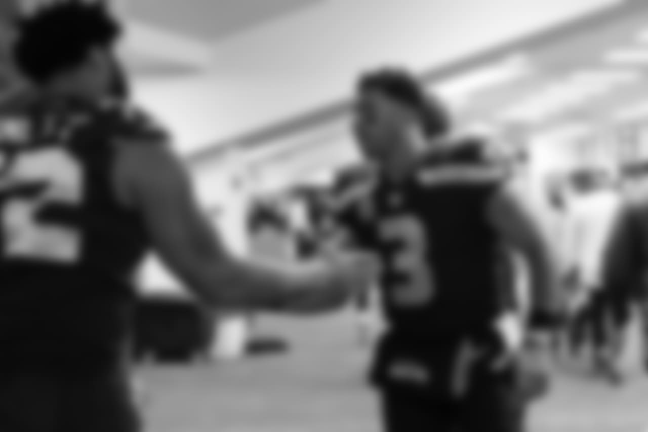 At halftime, quarterback Russell Wilson greeted teammates with encouragement as they returned to the locker room.