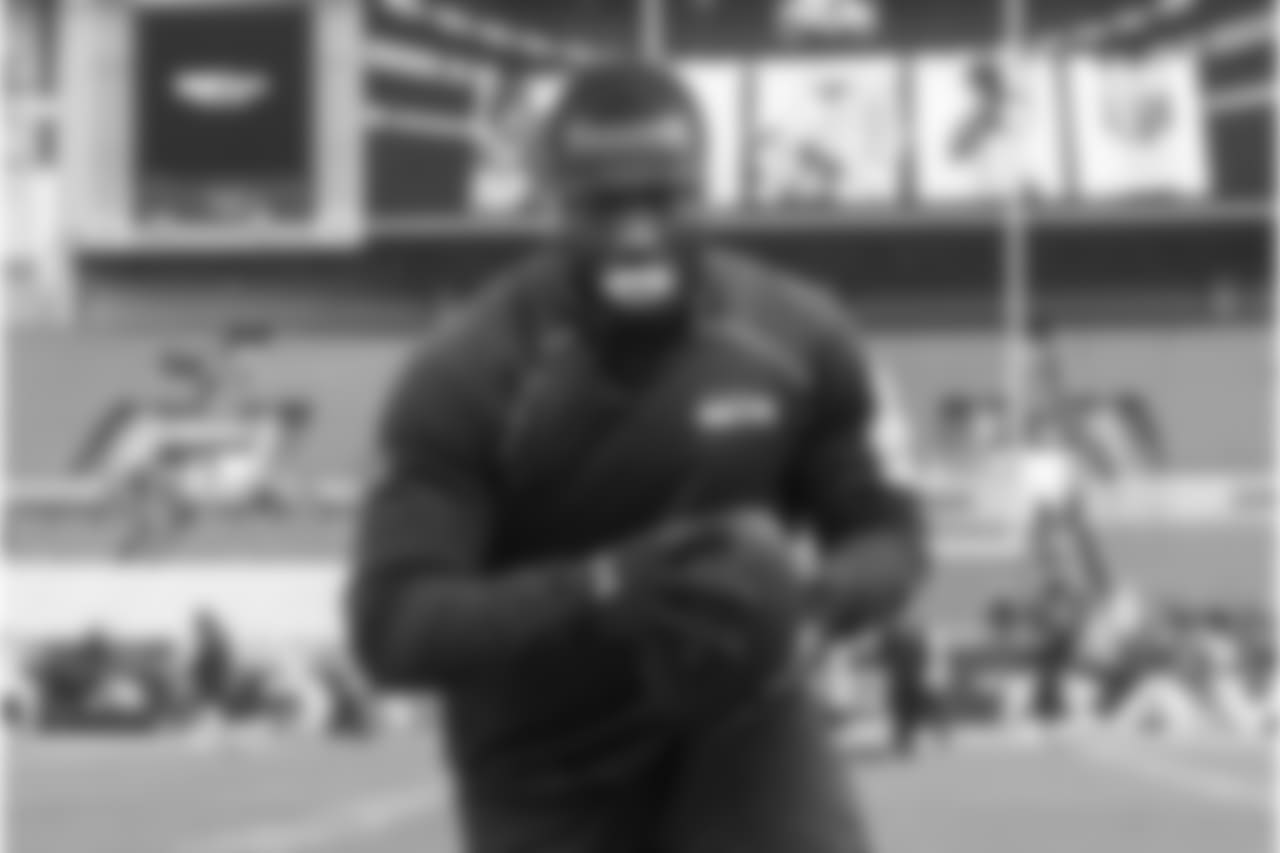 Linebacker Kevin Pierre-Louis, sporting his distinctive mouth guard, warms up before the game.