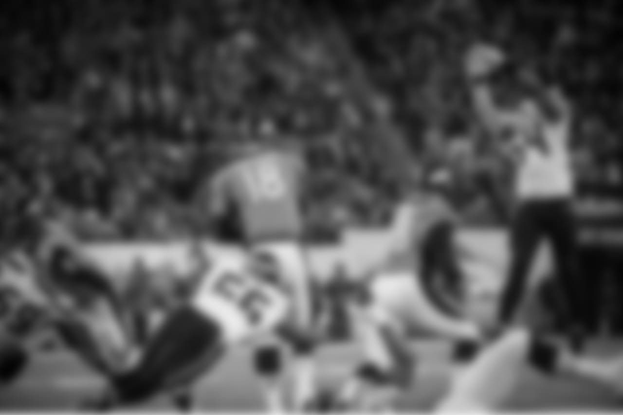 With pressure from the backside from Seattle's Cliff Avril, Denver quarterback Peyton Manning's pass sails past his intended receiver and the ball was intercepted by Seattle's Kam Chancellor