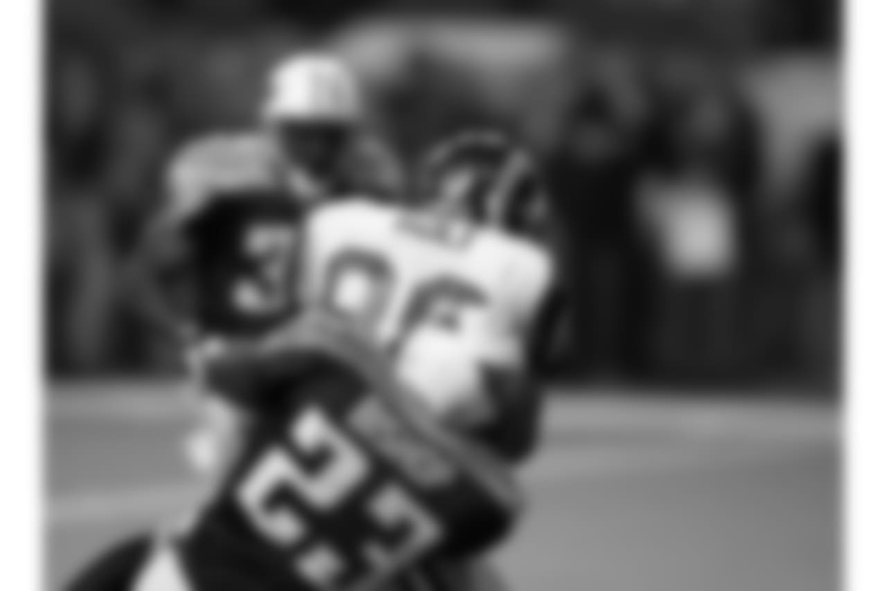 Tennessee Titans safety Blaine Bishop (23) stops St. Louis Rams wide receiver Torry Holt (88) during an NFL Super Bowl XXXIV game on Jan. 30, 2000. The Rams defeated the Titans 23-16. (Allen Kee via AP)