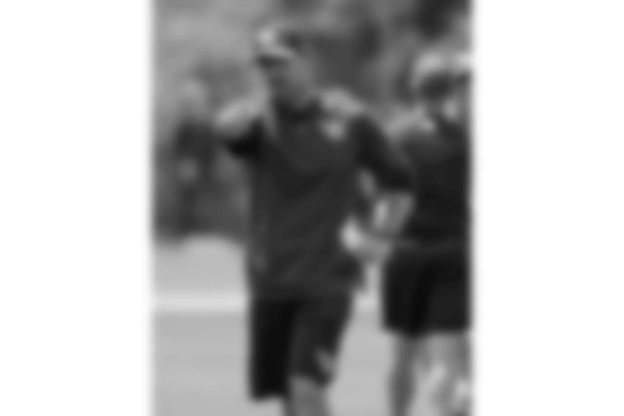 Tennessee Titans offensive coordinator Matt LaFleur runs a drill during an organized team activity at the Titans' NFL football training facility Tuesday, May 22, 2018, in Nashville, Tenn. (AP Photo/Mark Humphrey)