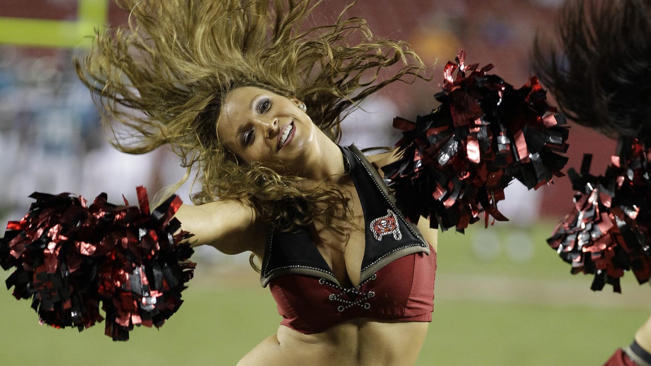 A member of the Washington Commanders cheerleaders performing on the field  during the second half of an NFL preseason football game against the  Cincinnati Bengals, Saturday, Aug. 26, 2023, in Landover, Md. (