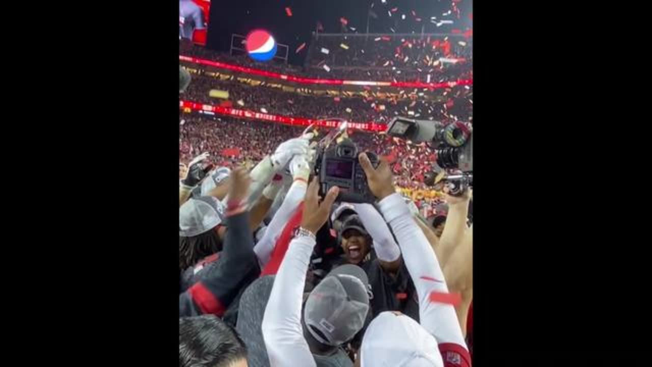 Niners players celebrate with George Halas Trophy