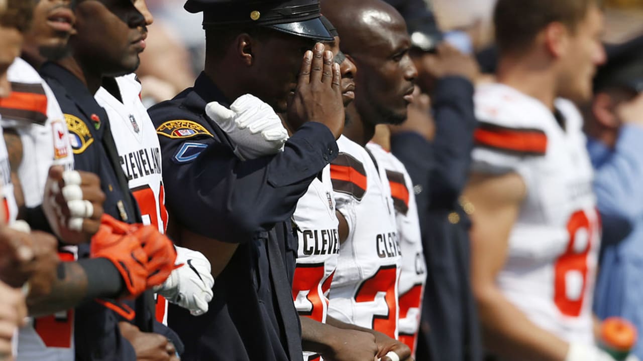 Cleveland Browns run out of tunnel with police and military personnel