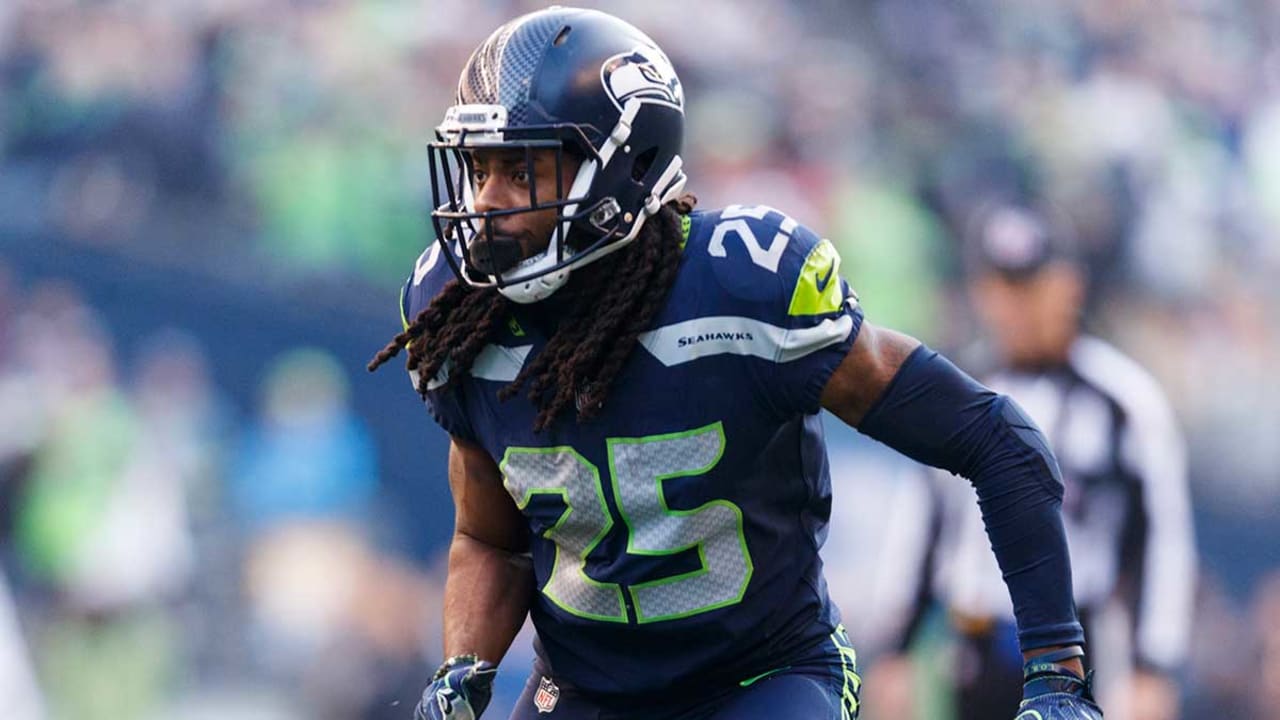 Richard Sherman (25) of the Seattle Seahawks intercepts a pass away from  Davante Adams (17) of the Green Bay Packers in the NFC Championship game at  CenturyLink Field in Seattle, Washington on