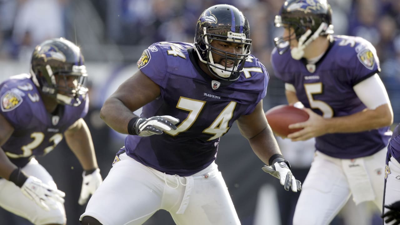 Michael Oher, a tackle from Mississippi, holds up a jersey after