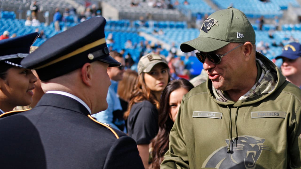 Miami Dolphins players and coaches wear camouflage as a Salute To Service  as they warm up before an NFL football game against the Carolina Panthers  in Charlotte, N.C., Monday, Nov. 13, 2017. (