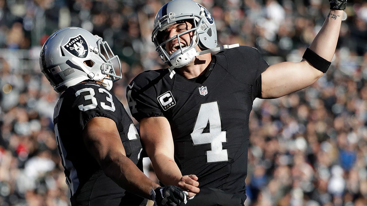 Oakland Raiders center Jim Otto on field with George Buehler