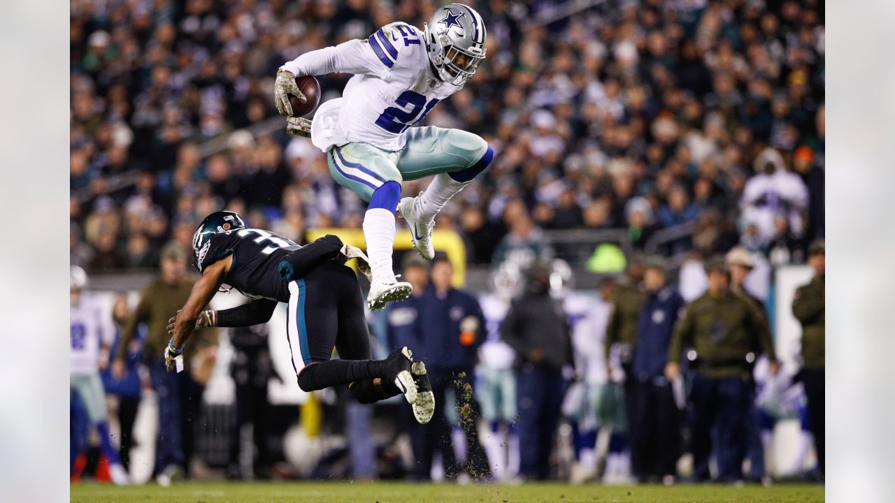 Dallas Cowboys running back Ezekiel Elliott (21) hurdles Philadelphia  Eagles defensive back Tre Sullivan (37) during