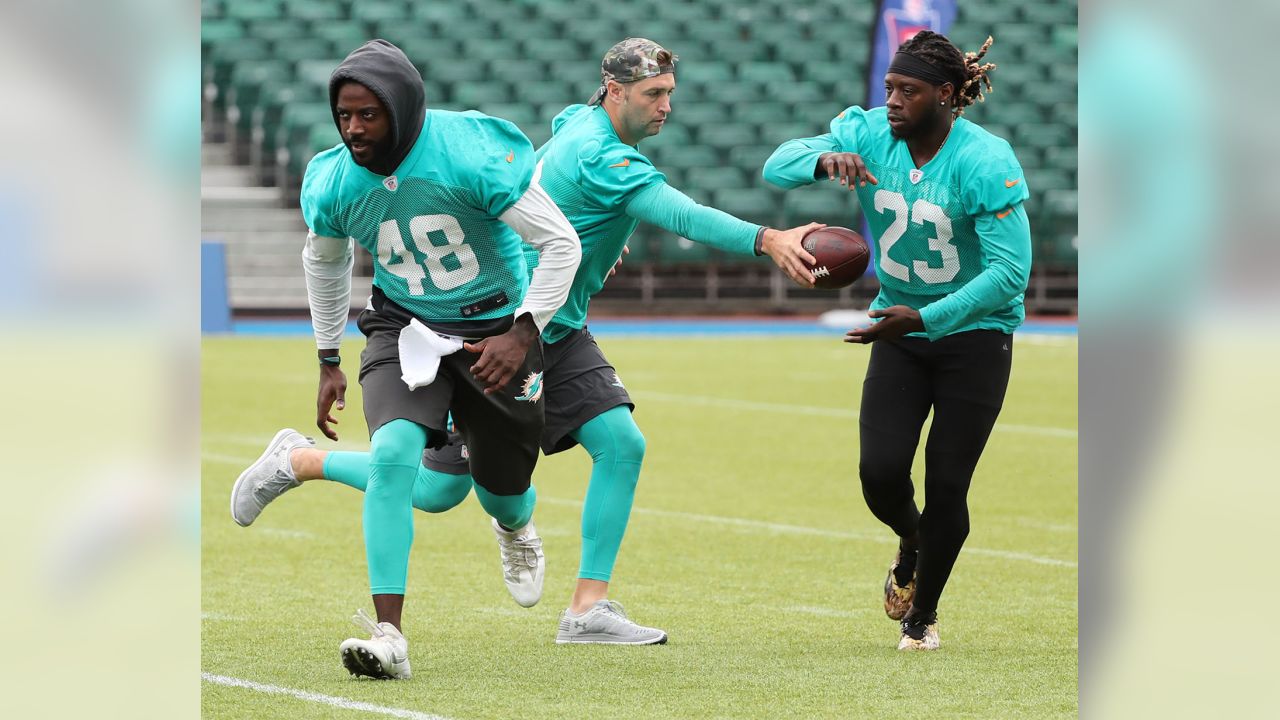 Miami Dolphins running back Jay Ajayi, left, and quarterback Jay Cutler  look across the field during a training session at Allianz Park in London,  Friday Sept. 29, 2017. The Miami Dolphins are