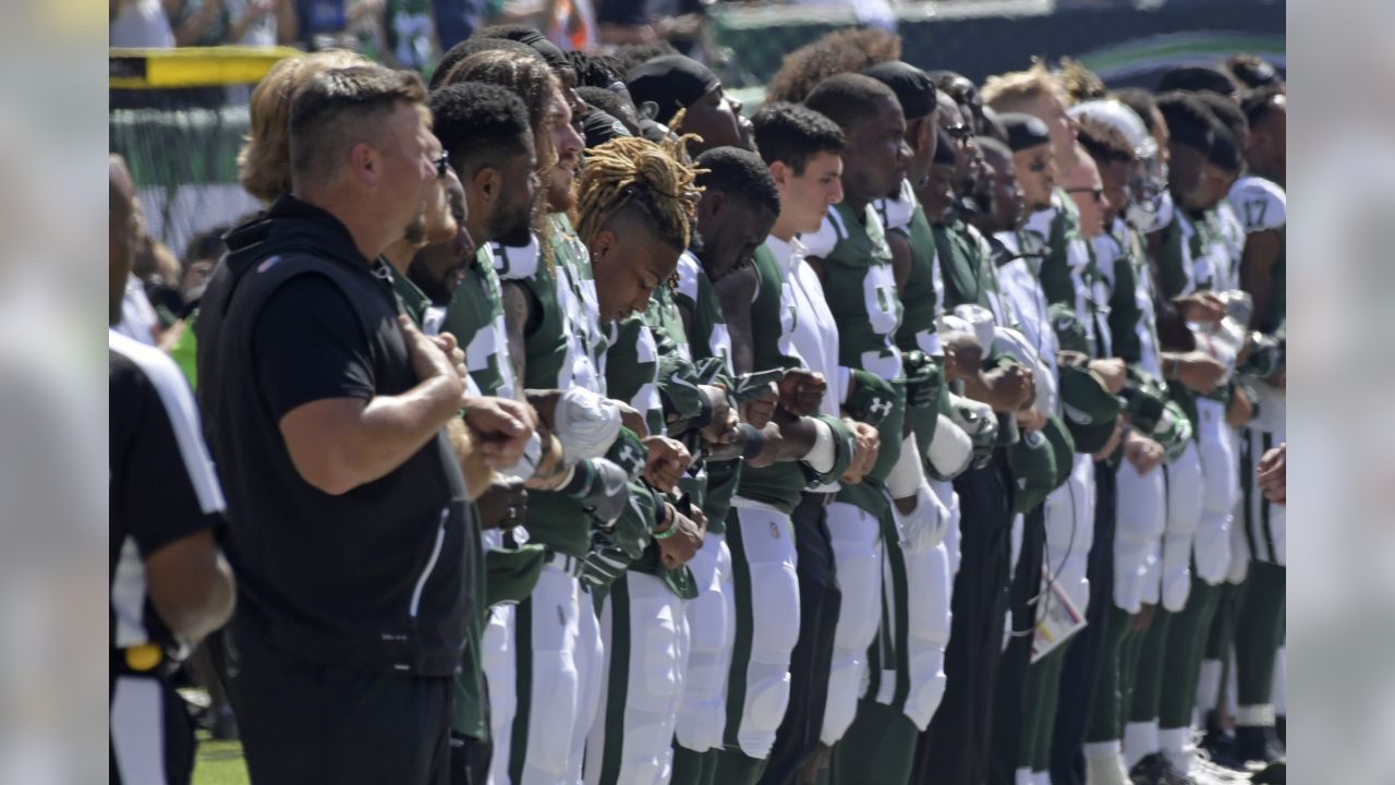 New York Jets lock arms, four Miami Dolphins kneel during national