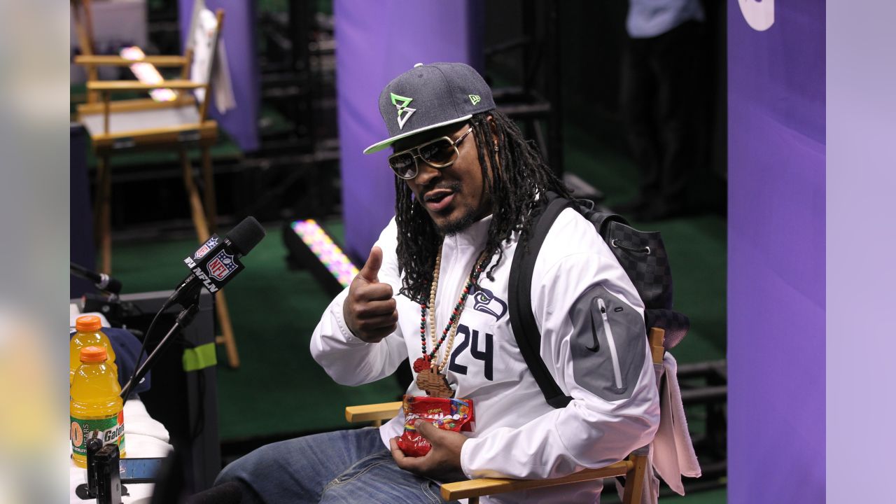 Seattle Seahawks running back Marshawn Lynch (24) holds a bottle