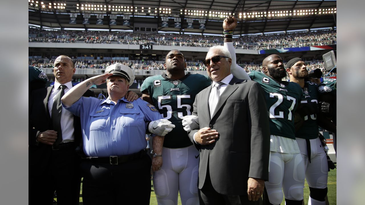 New York Jets players stand as the National Anthem is sung prior