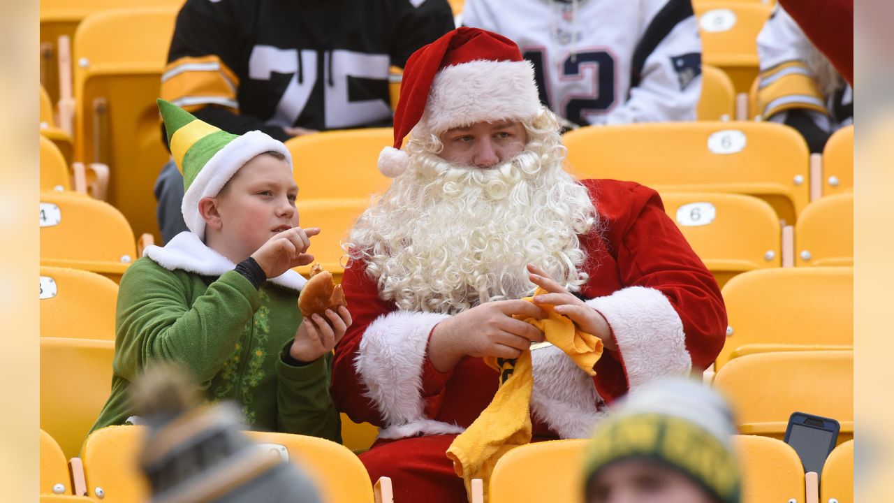 An Arizona Cardinals fan, dressed as Santa Claus, cheers during the first  half of an NFL football game against the Indianapolis Colts, Saturday, Dec.  25, 2021, in Glendale, Ariz. (AP Photo/Rick Scuteri