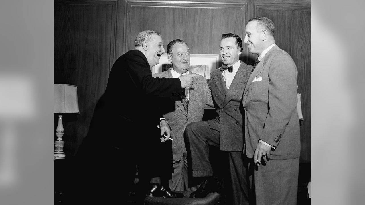 Bert Bell, center, of Philadelphia, receives congratulations in Chicago  Jan. 20, 1949 fronm George Halas Jr., left, and Charles W. Bidwell Jr.  after being presented with a 10-year contract to continue to