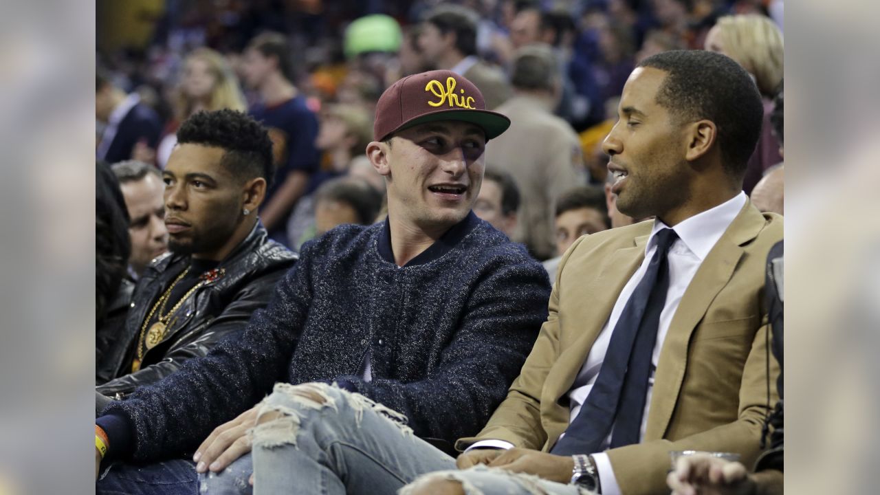 NFL players and coaches take in the NBA